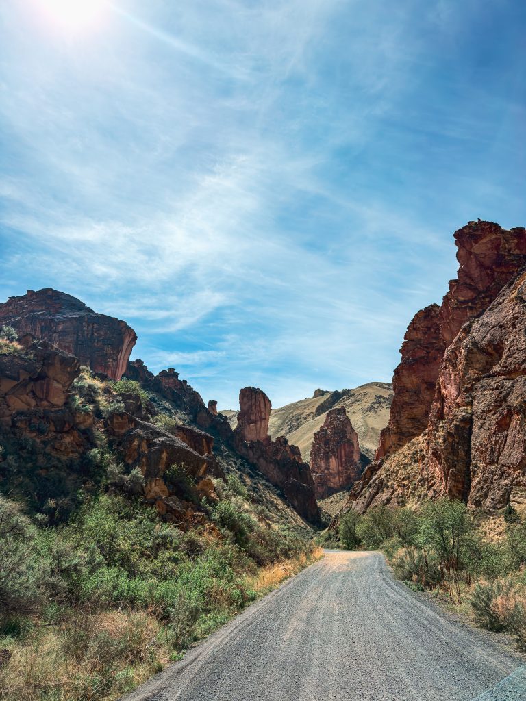 Gravel road winding between rock formations in Leslie Gulch, Oregon